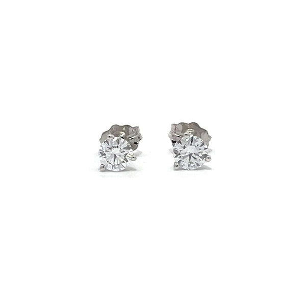 Pair of white gold stud earrings with a triangular setting of diamonds on a white background.