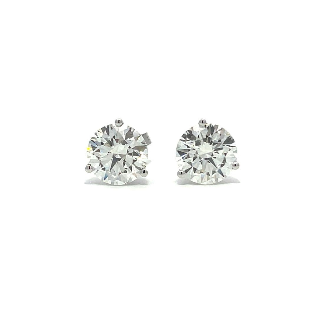 White gold stud earrings with round diamonds on a white background.