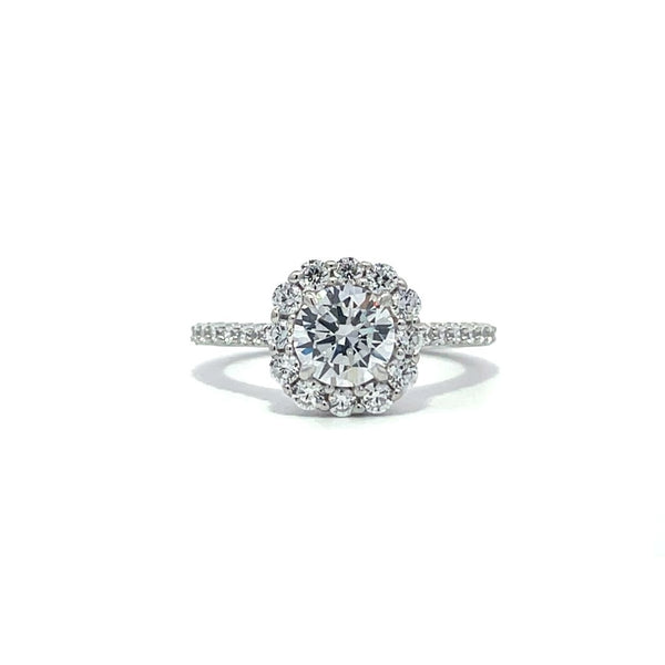 Silver engagement ring with a diamond halo setting and a diamond band on a white background