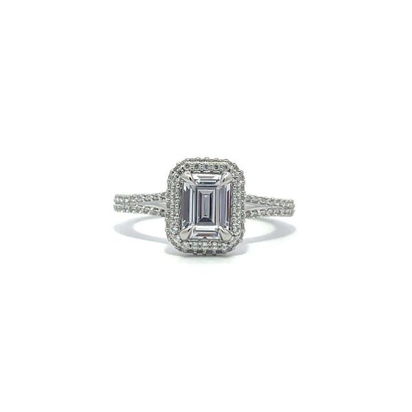 Silver emerald-cut engagement ring with a double halo setting on a white background