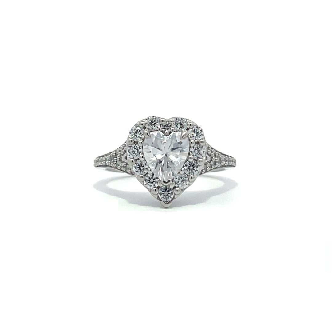 Silver heart-shaped diamond engagement ring with a halo setting and split shank on a white background.