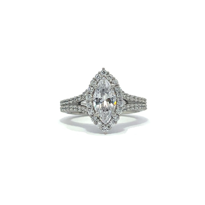 Silver marquise-shaped diamond engagement ring with a halo setting and split shank on a white background.