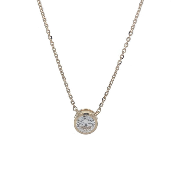 Yellow gold necklace with a round diamond solitaire pendant on a white background.