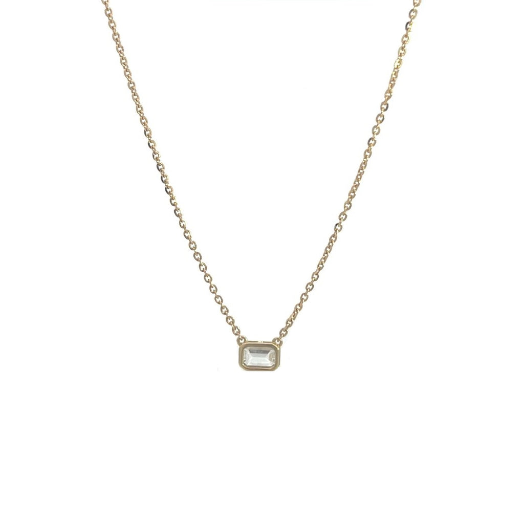 Yellow gold necklace with an emerald-cut diamond pendant on a white background.