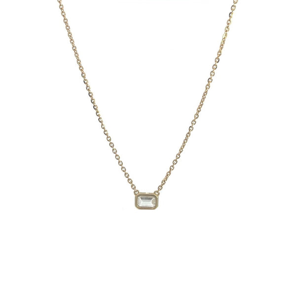 Yellow gold necklace with an emerald-cut diamond pendant on a white background.