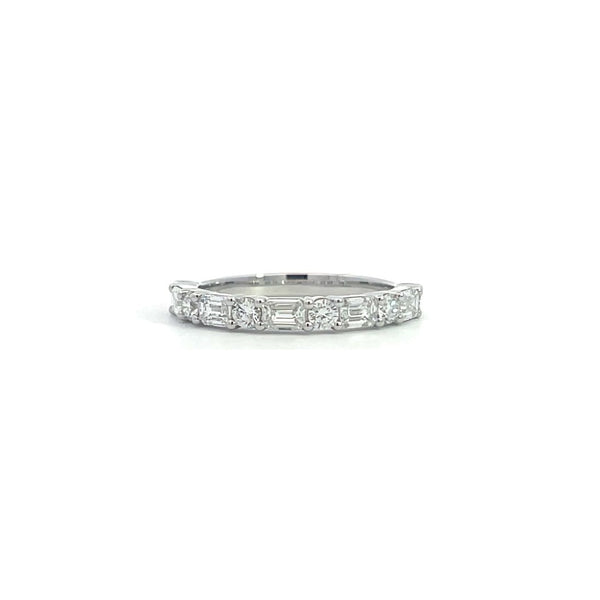 SIlver eternity band with alternating round and baguette-cut diamonds, on a white background.