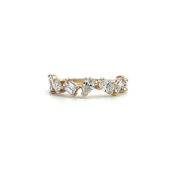 Yellow gold ring with a row of mixed-cut diamonds, including round, pear, and emerald cuts, on a white background.