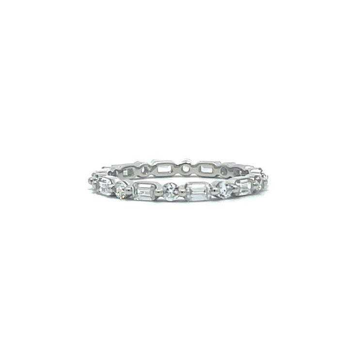 Silver eternity ring with round and baguette stones on a white background