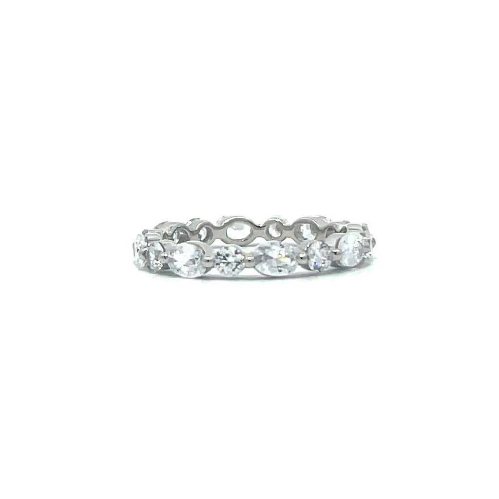 Silver eternity ring with oval and round stones on a white background.