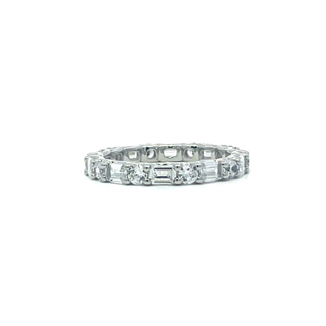 Silver eternity ring with baguette stones on a white background.