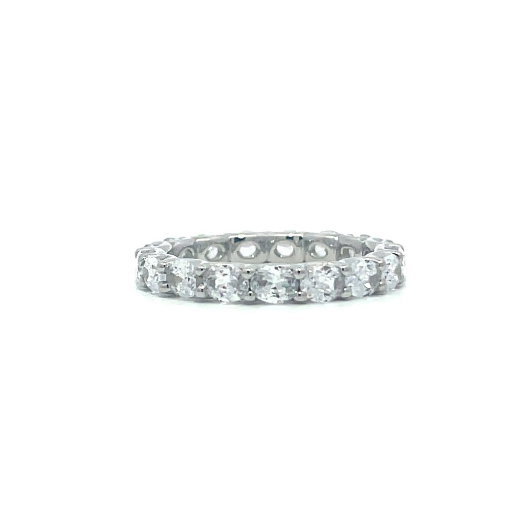 Silver eternity ring with round stones on a white background.