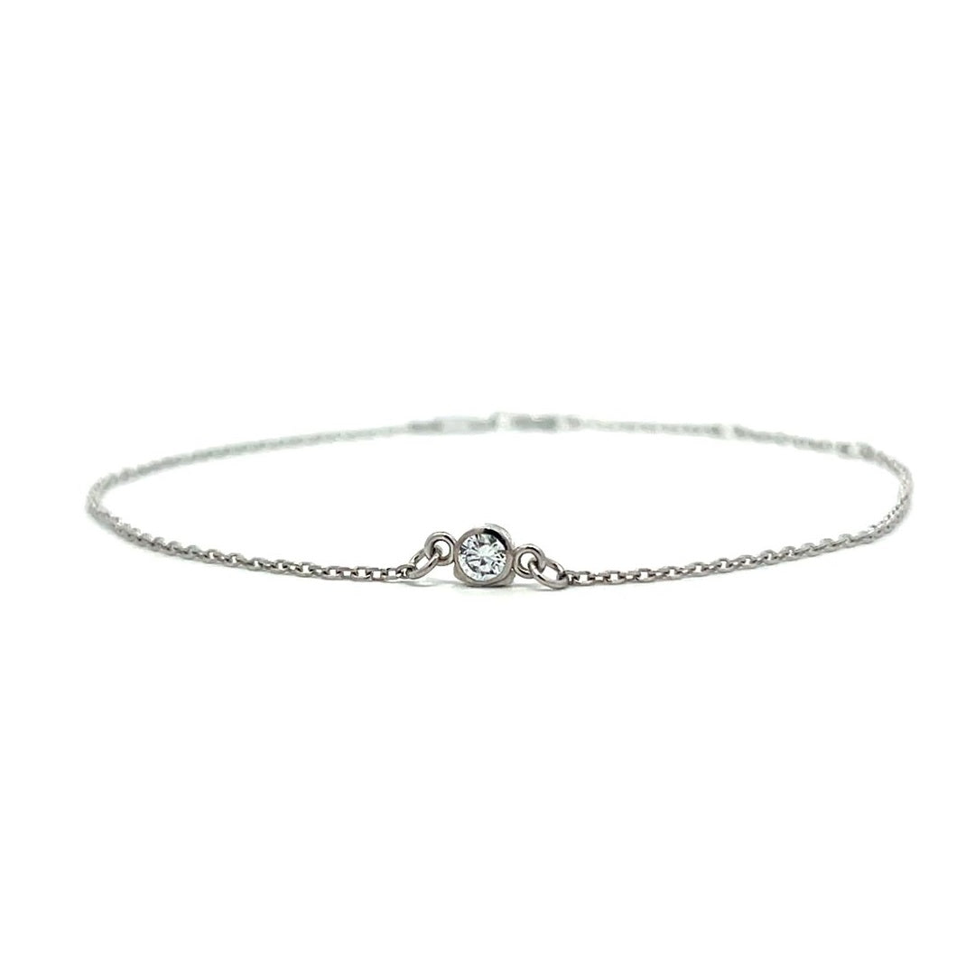 Silver bracelet with a single diamond pendant on a white background.