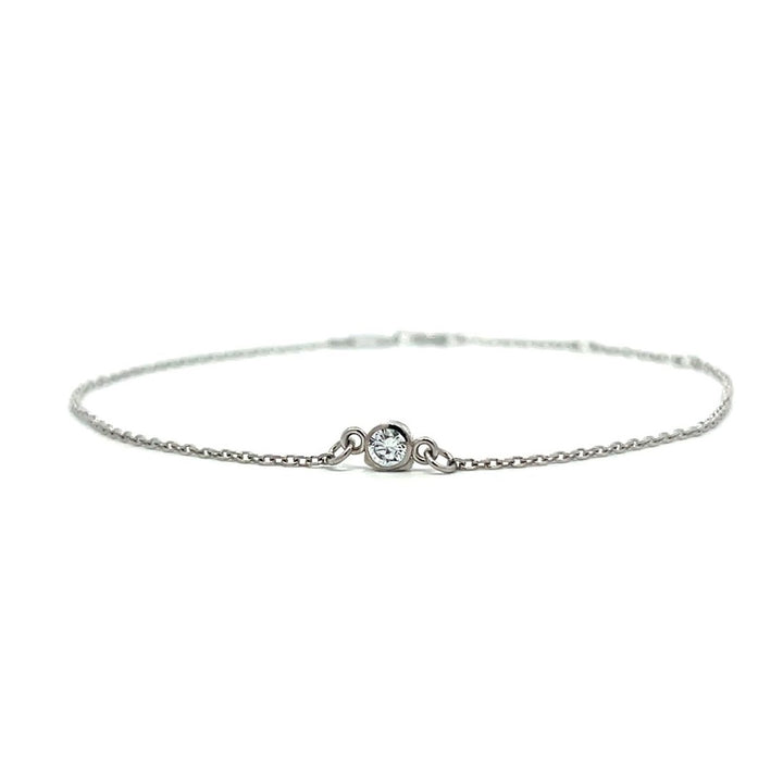 Silver bracelet with a single diamond pendant on a white background.