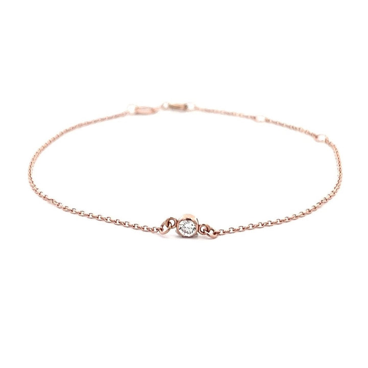 Rose gold bracelet with a single diamond on a white background.