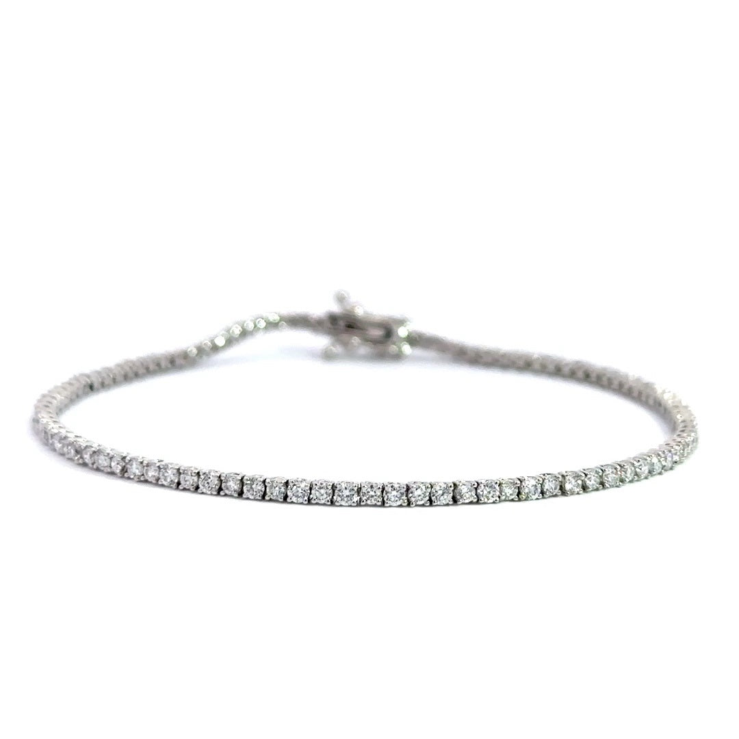 Silver diamond tennis bracelet on a white background.