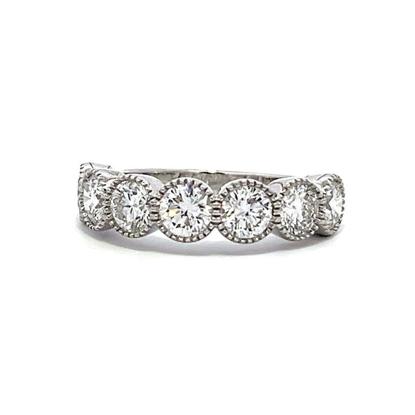 White gold eternity band with bezel-set round diamonds on a white background.