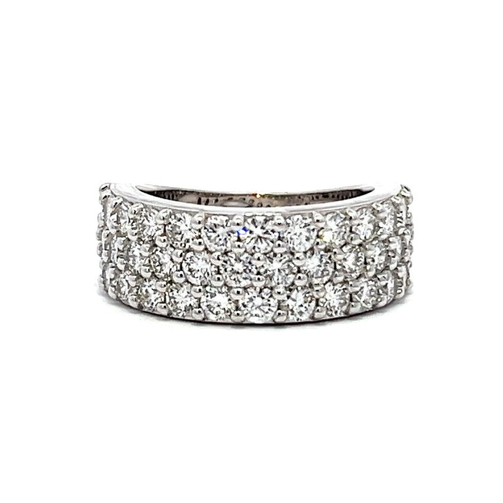 White gold eternity band with three rows of pave-set diamonds on a white background.