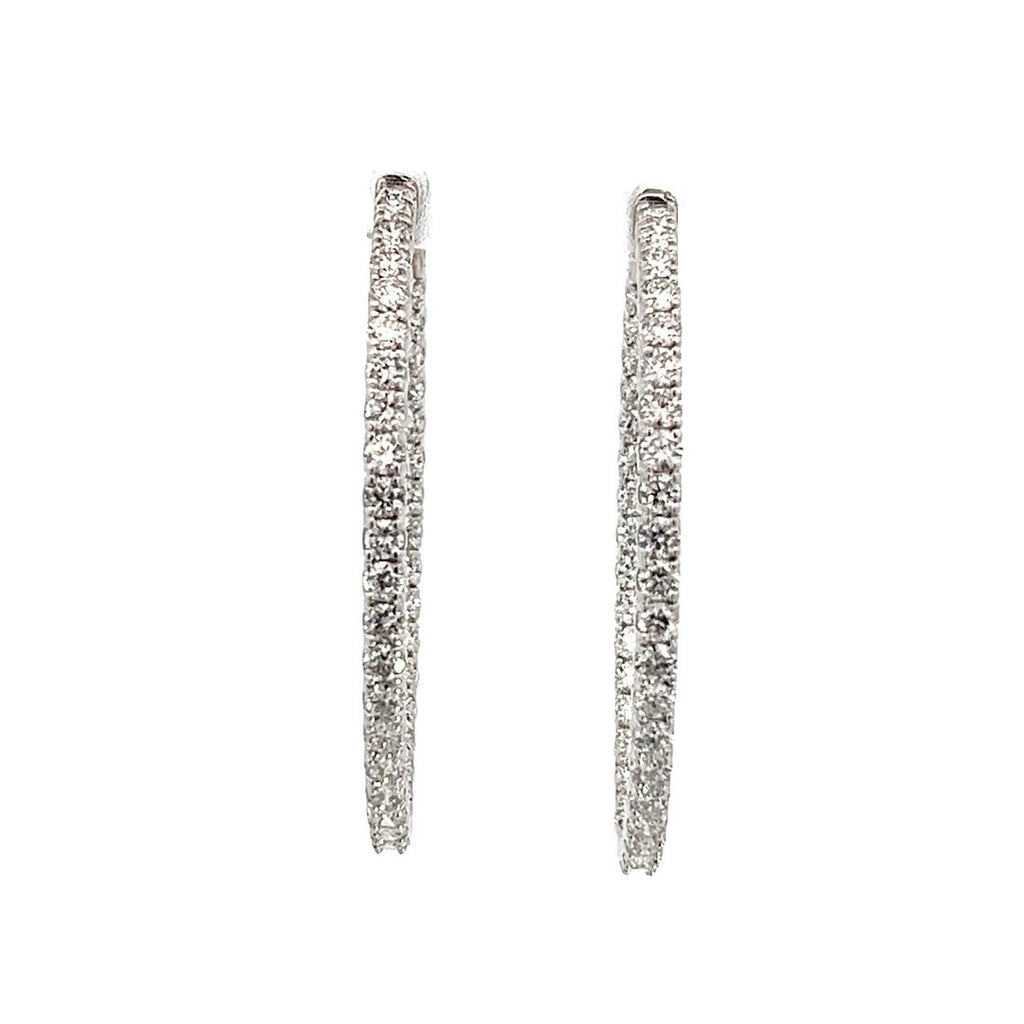 White gold diamond hoop earrings on a white background.