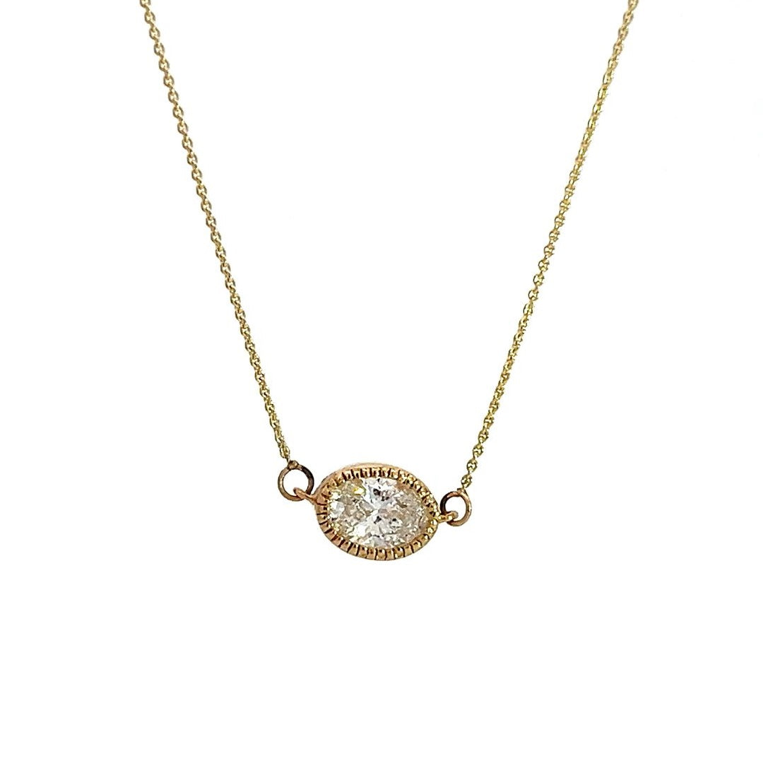 Yellow gold necklace with an oval-shaped diamond pendant on a white background.