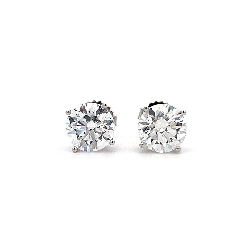 White gold stud earrings with round diamonds on a white background.