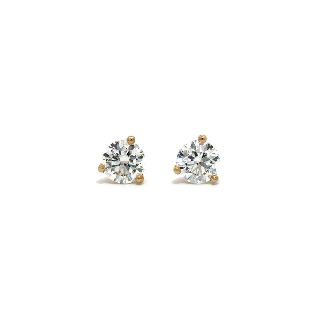 Pair of yellow gold stud earrings with a prong setting of diamonds on a white background.