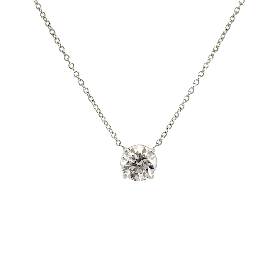 Diamond solitaire necklace on a white background.