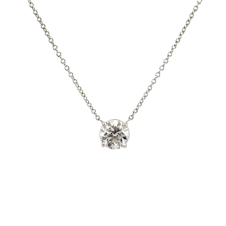 Diamond solitaire necklace on a white background.