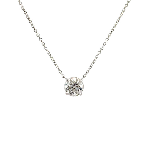 Diamond solitaire necklace on a white background.