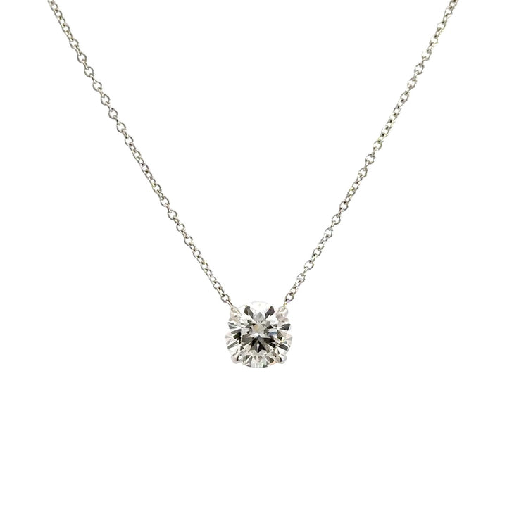 Diamond solitaire necklace on a white background.