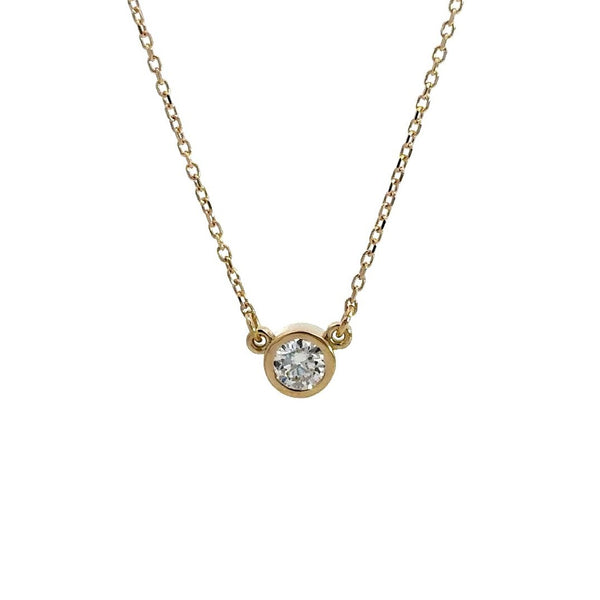 Yellow gold diamond solitaire necklace on a white background