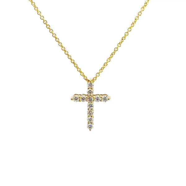 Yellow gold diamond cross necklace on a white background