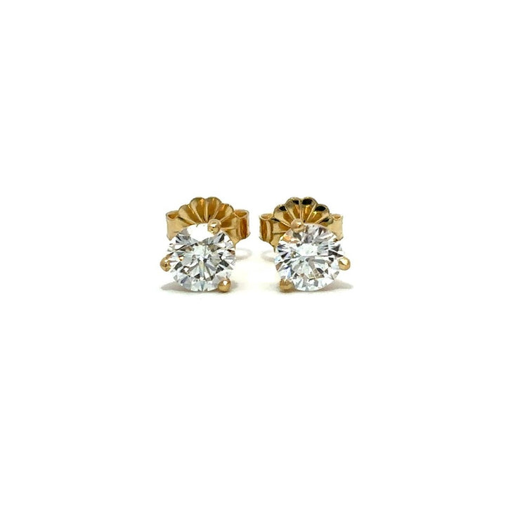 Yellow gold diamond stud earrings on a white background