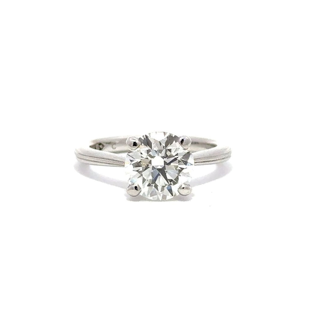 Front view of silver engagement ring with a round-cut center diamond.