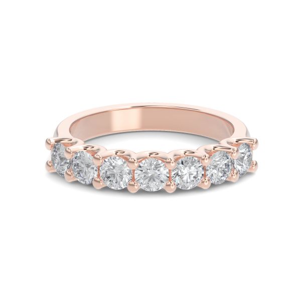 Rose gold wedding band with diamond accent on a white background.