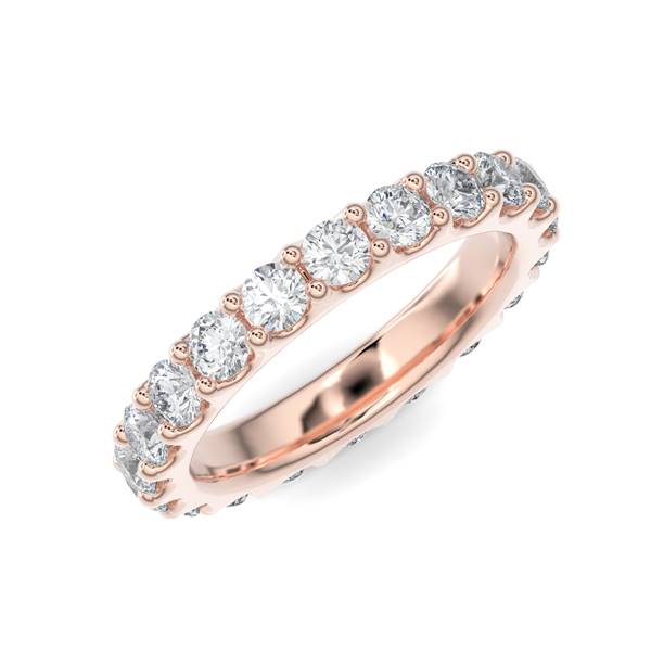 Rose gold wedding band with diamond accent on a white background.