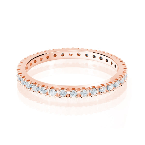 Rose gold wedding band with diamond accents on a white background.