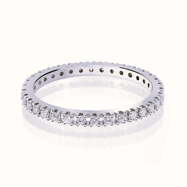 White gold wedding band with diamond accents on a white background.