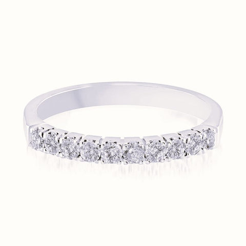 White gold wedding band with diamond accents on a white background.