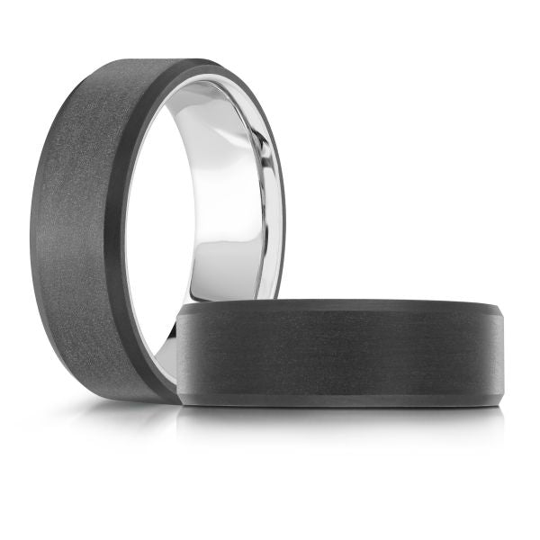 White gold black ceramic wedding band ring on a white background.