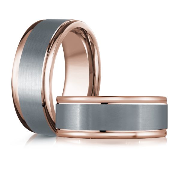 Rose gold black ceramic wedding band ring on a white background.