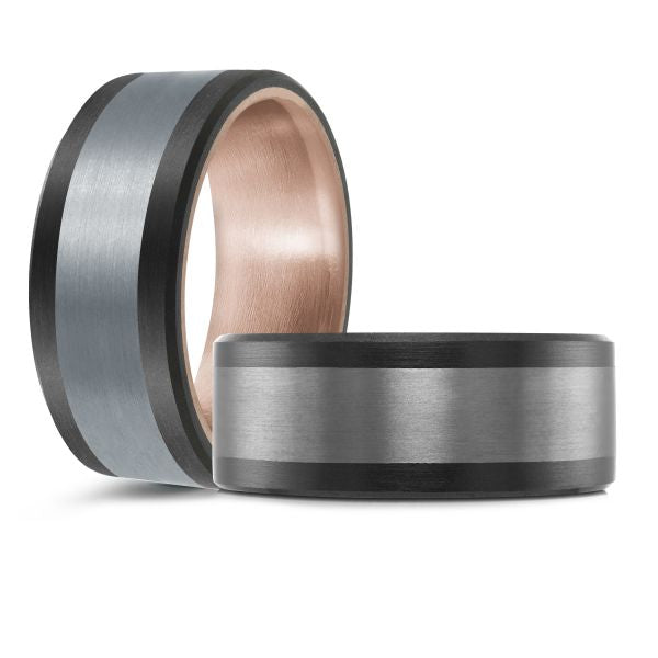 Black ceramic wedding band with a rose gold interior and a brushed silver inlay on a white background