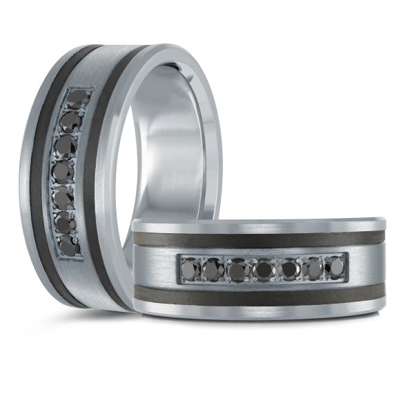  Two black ceramic wedding bands with brushed silver inlays and black diamonds, on a white background.