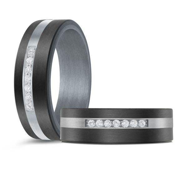 Black ceramic wedding band with a silver inlay and diamond accent and diamonds on a white background.