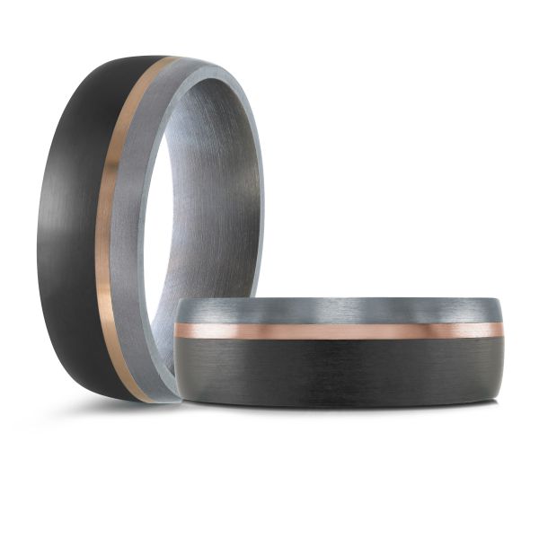 Black ceramic wedding band with a white gold inlay on a white background