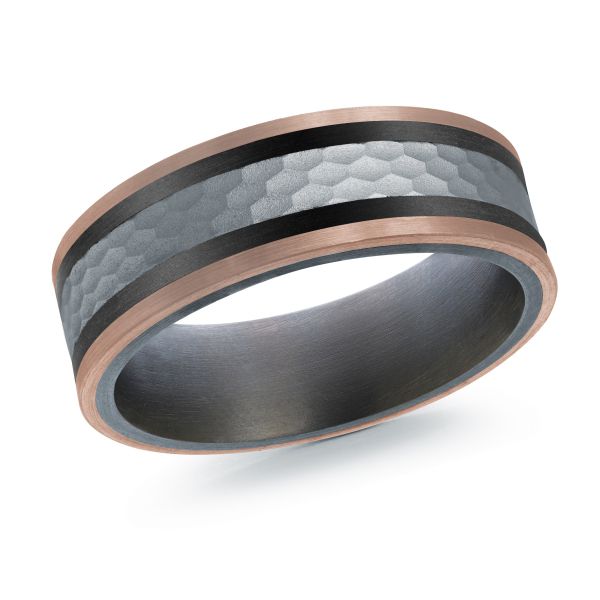 Black ceramic wedding band with a rose gold and hammered metal inlay on a white background