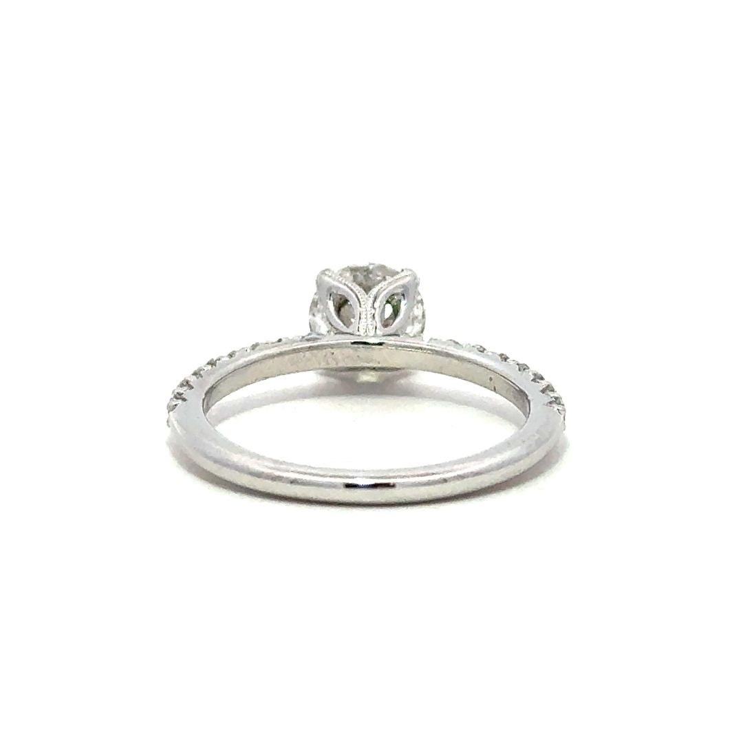 Back view of a silver engagement ring with a round-cut center diamond.