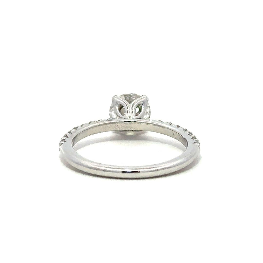 Back view of a silver engagement ring with a round-cut center diamond.