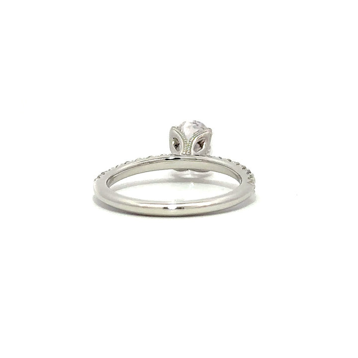 Back view of a silver engagement ring with a round-cut center diamond.