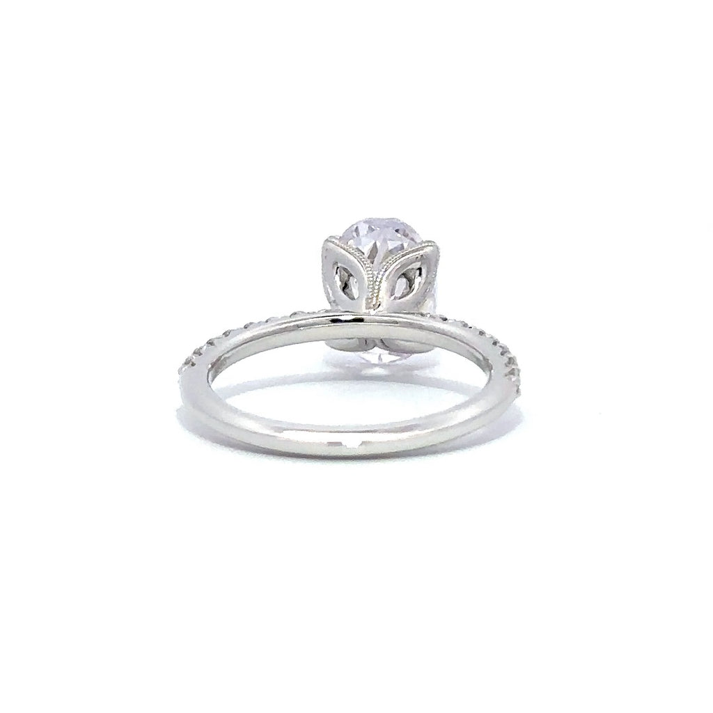 Back view of a silver engagement ring with a round-cut center diamond.