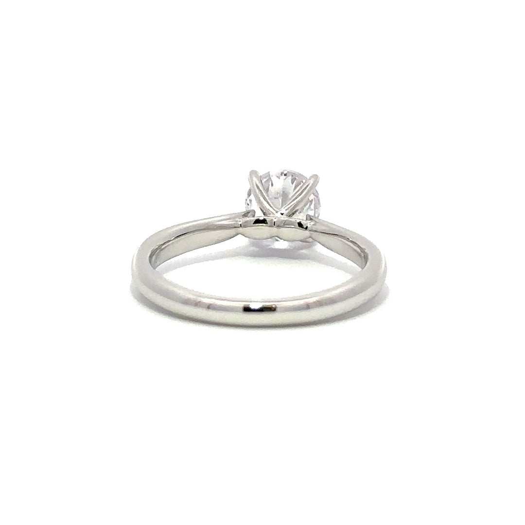 Back view of silver engagement ring with a round-cut center diamond.